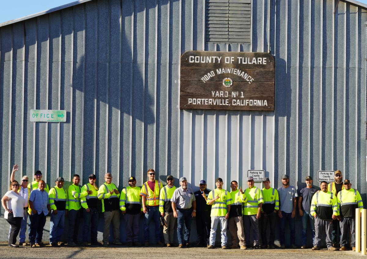 Tony Boland stands with the Road Maintenance Yard No. 1 crew outside the Tulare County road yard in Porterville, where he began his career with the County.