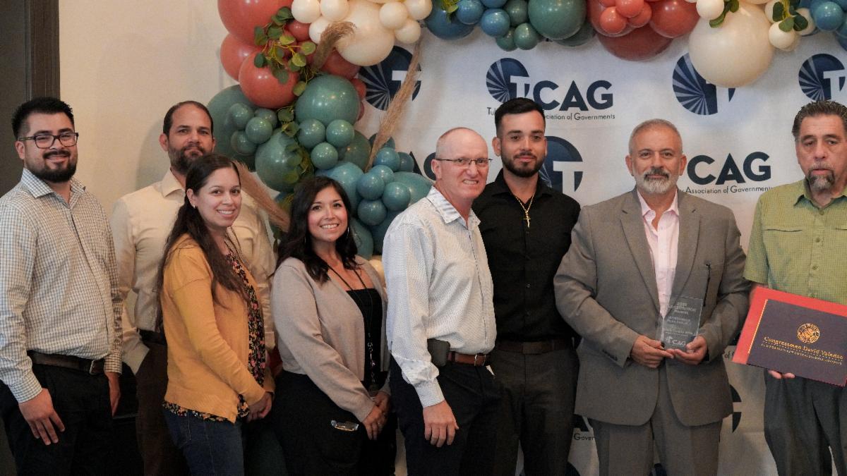 Tulare County RMA staff pose with project partners during a TCAG LocalMotion Awards presentation recognizing an outstanding road project.