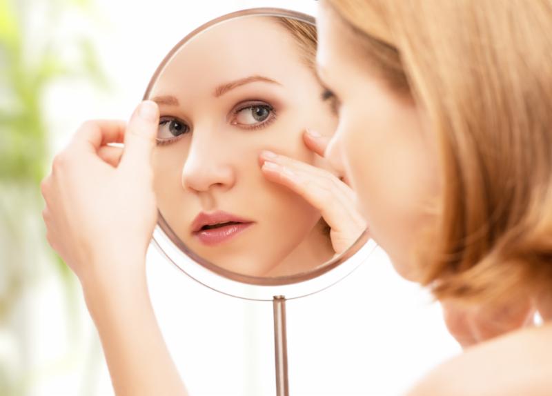 woman_looking_face_mirror.jpg