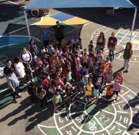 Picture of students and staff in the school playground 