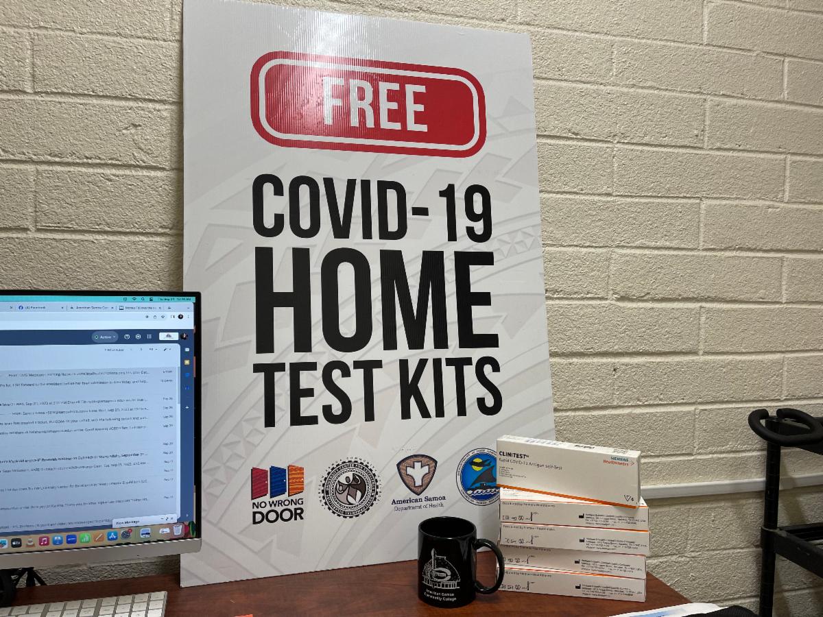 Free COVID-19 home test kits sign on a desk