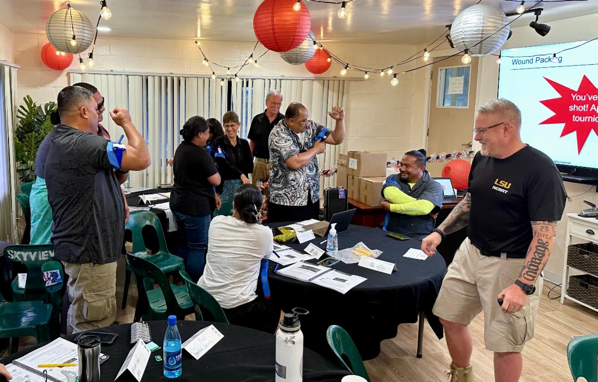 Participants learning how to put on a CAT tourniquet. 