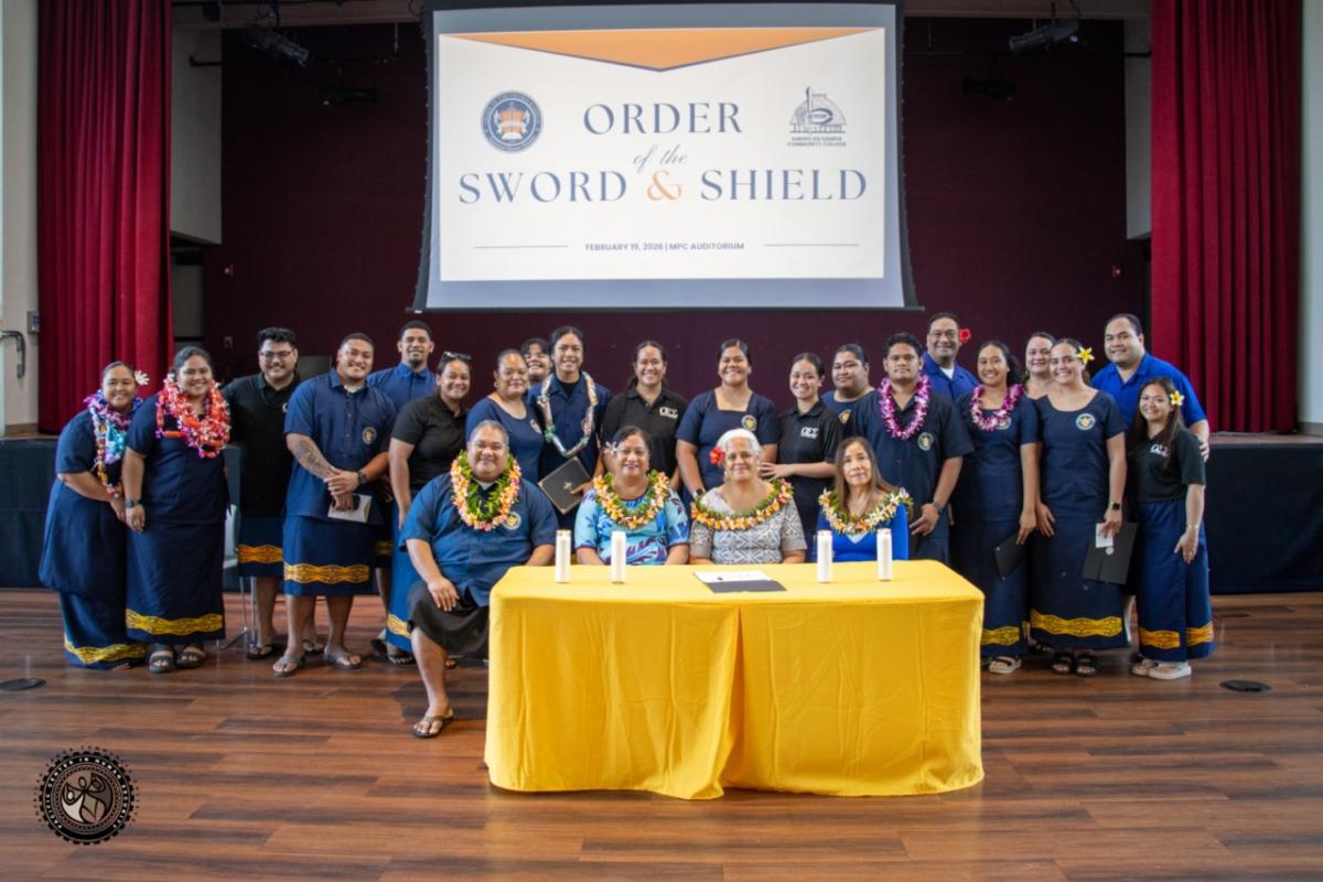 Group photo of OSS inductees, members and ASCC admins in front of OSS sign.