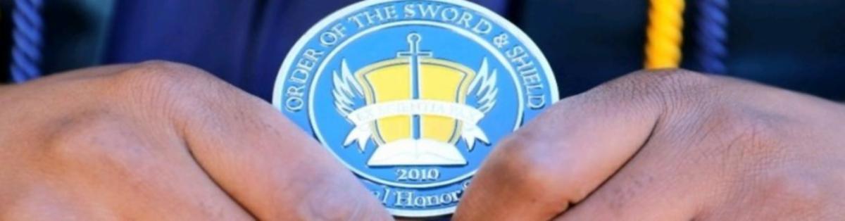 Close up of someone holding an OSS medallion. 