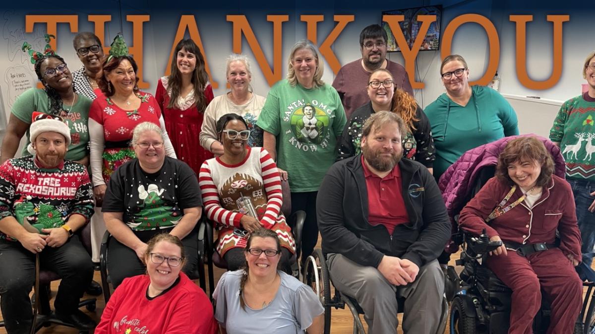 Photo of staff at holiday party, wearing festive attire and smiling.