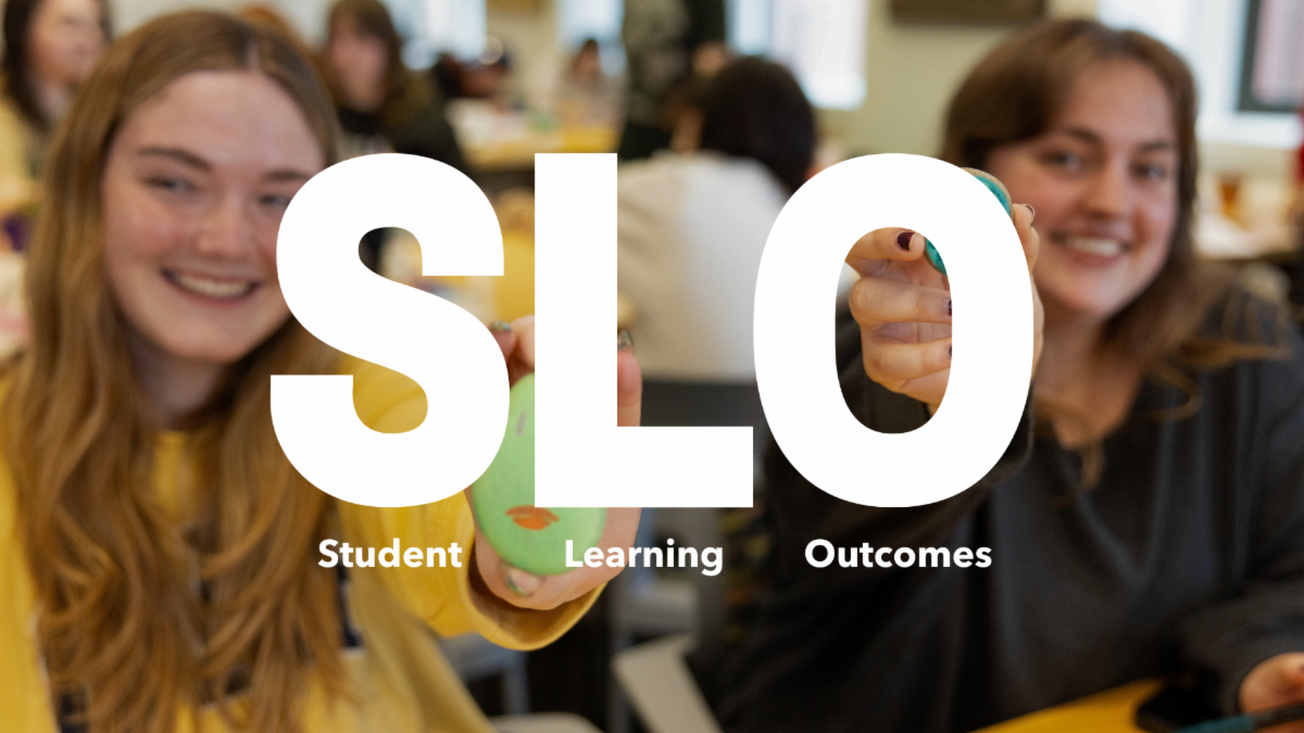 A photo of two Emerson students smiling in the background with text on top of it that says Student Learning Outcomes