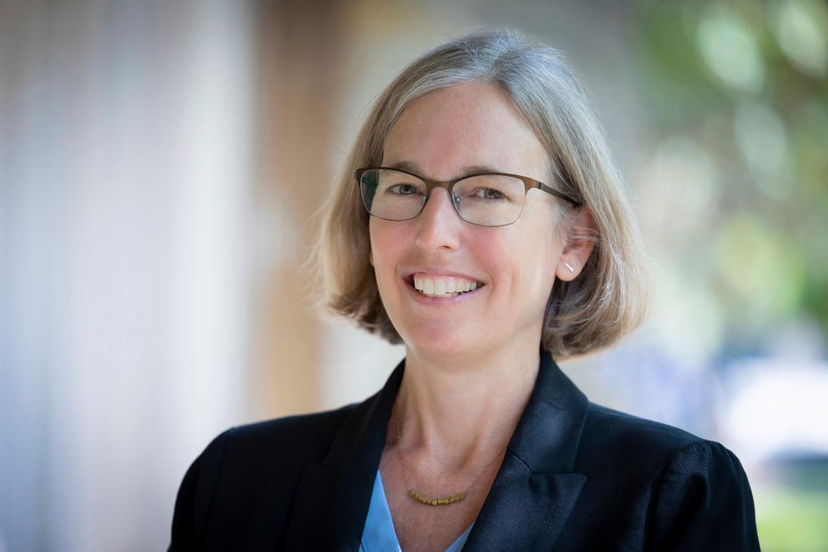 woman wearing glasses smiling outdoors
