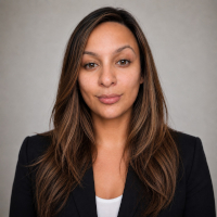 woman in black blazer and white shirt looking forward