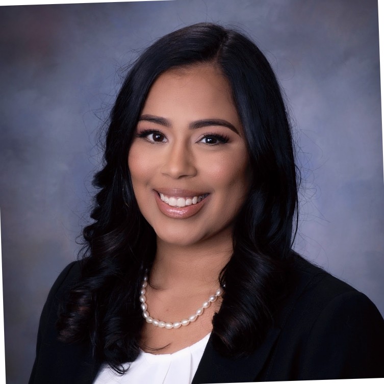 woman in black blazer and white shirt smiling