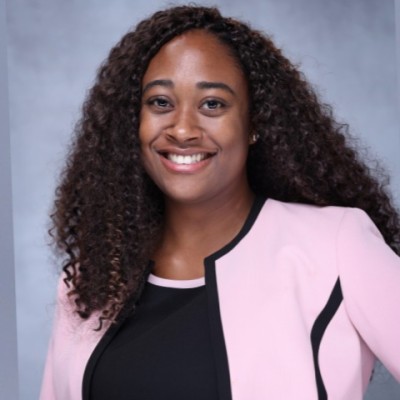 woman smiling in pink business attire