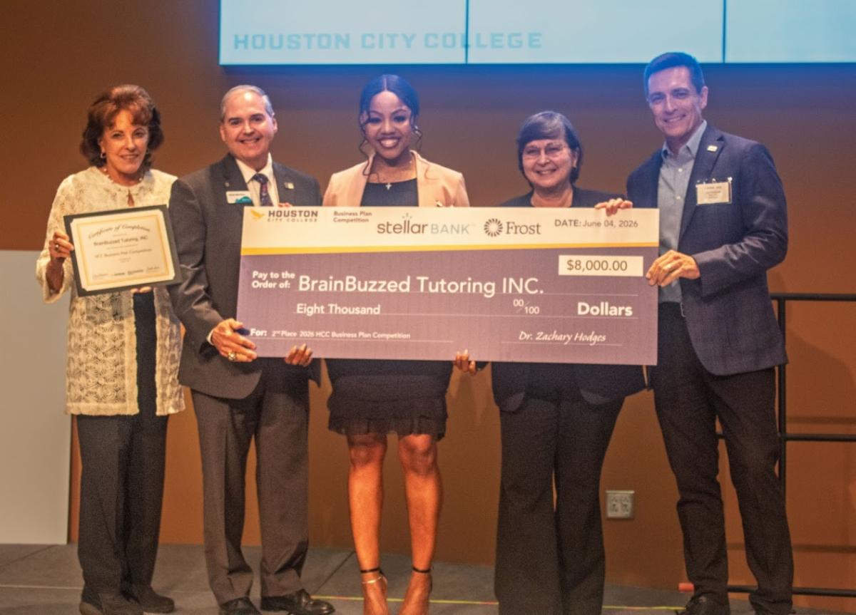 On stage - 2nd Place Winner and $8,000 awarded to Brainbuzzed Tutoring, Inc., - Patience Edwards
