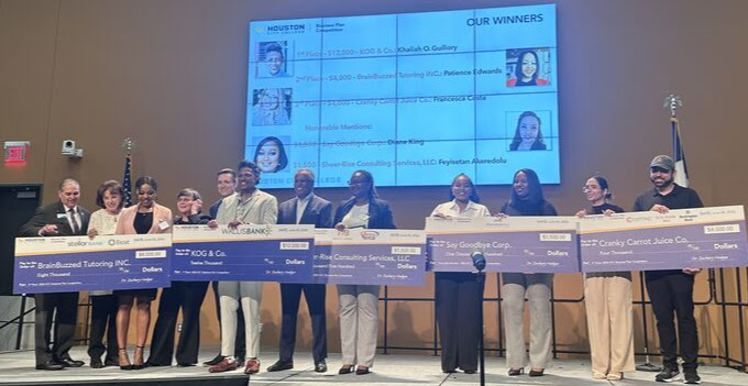 Photo - All five top prize winners on stage with their poster board checks and the sponsors - 2026 HCC Business Plan Competition