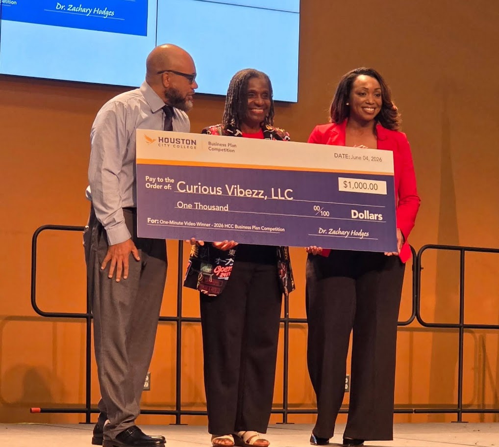2026 One-Minute Video Prize Winner HCC Business Plan Competition:  Curious Vibezz, LLC, DeLisa Jones, being presented her $1,000 poster board prize check.