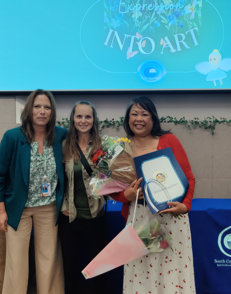 Jennifer Simpson posing with fellow staff at District Staff Awards