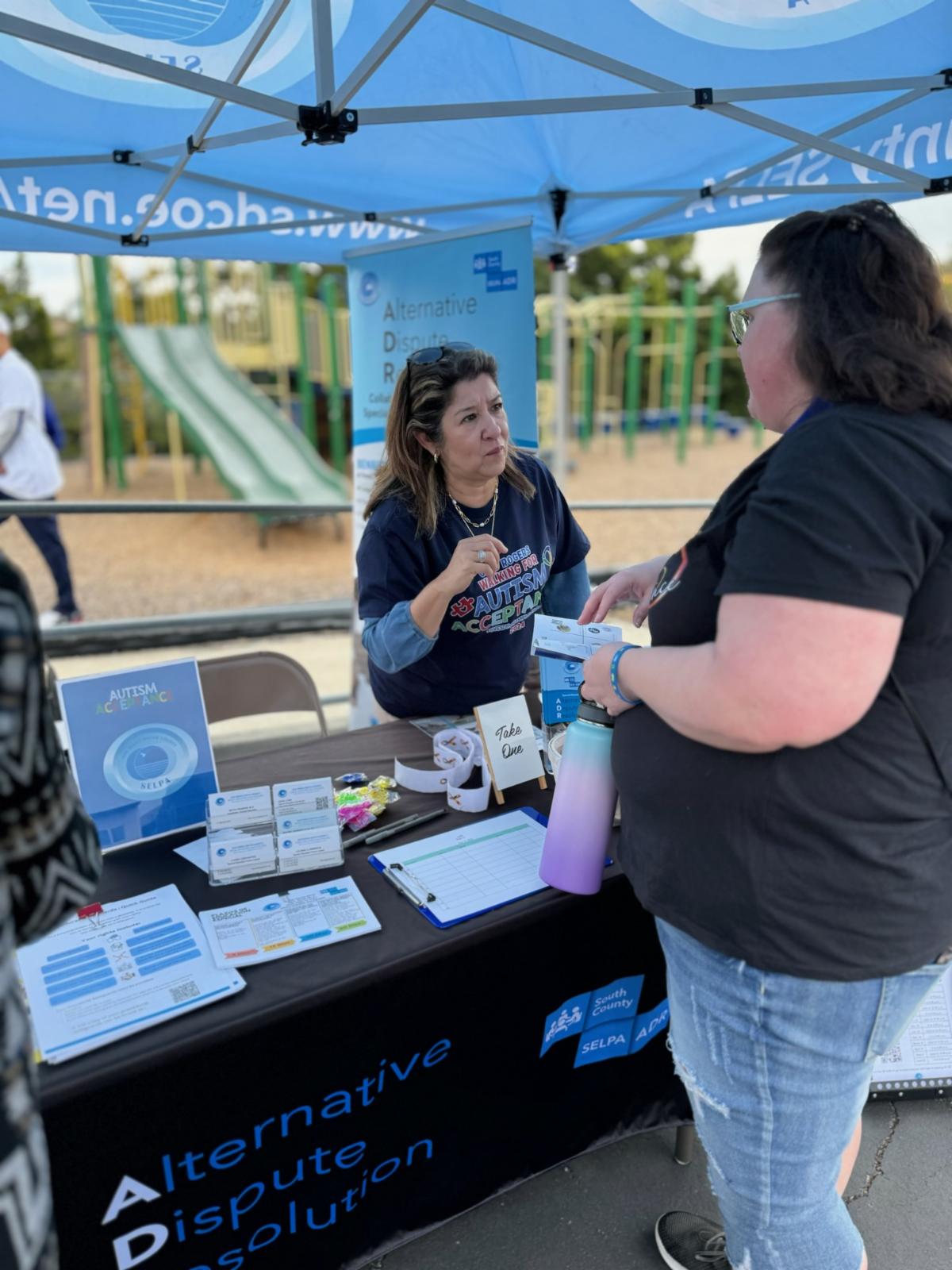 Image of staff and parent at resource fair