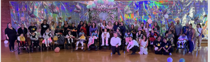 Friendship students posing together in front of an enchanted garden theme backdrop at prom