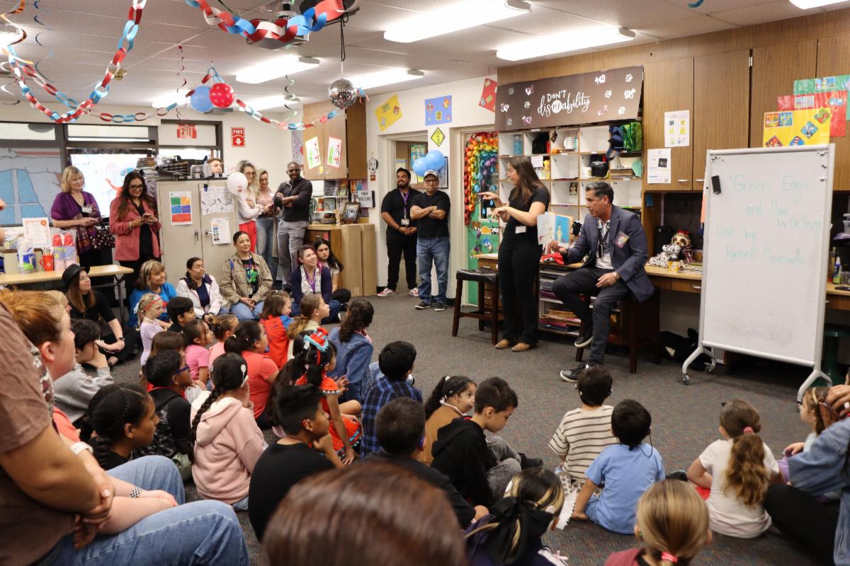 Davila students gathered to listen to a story being read and signed in ASL