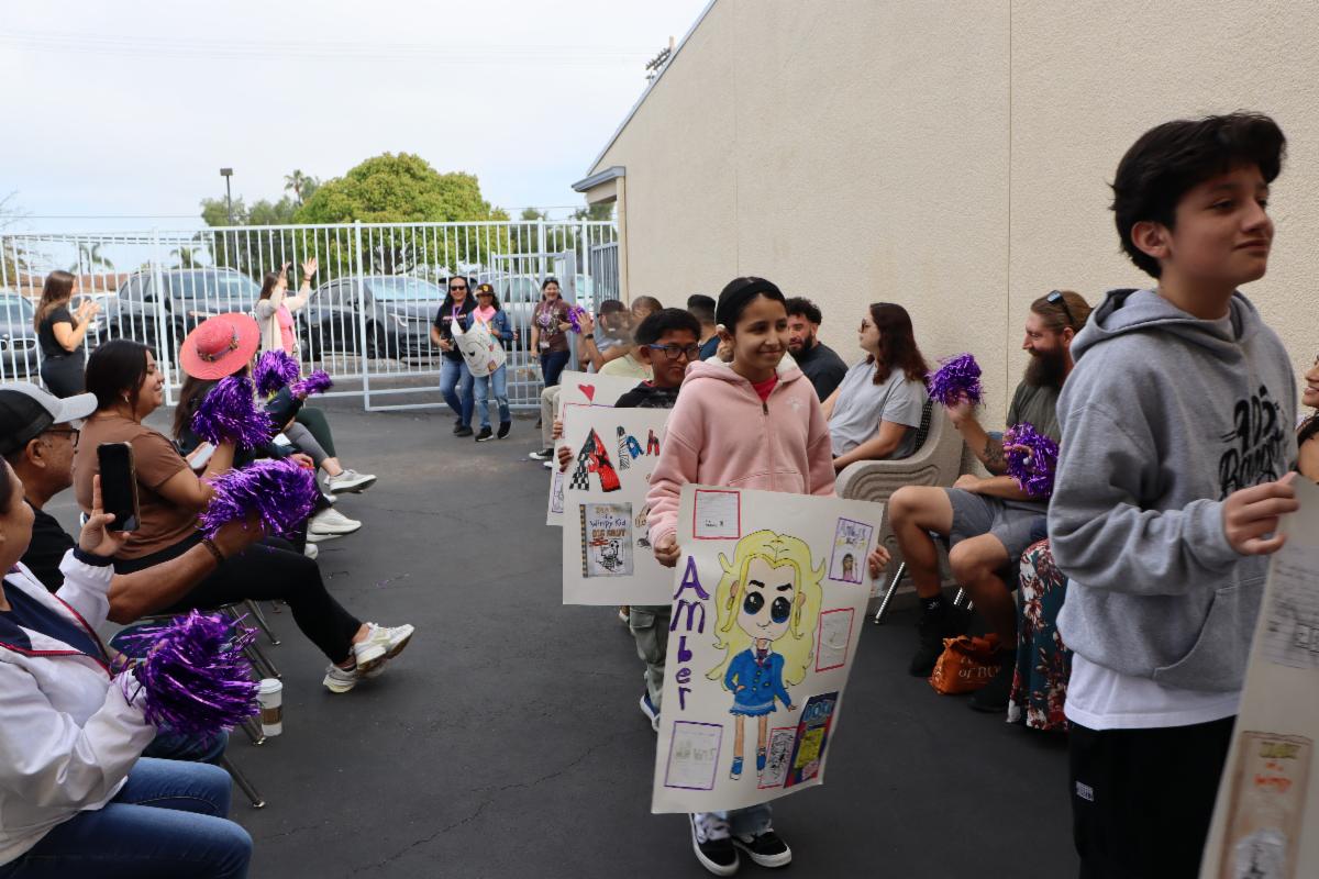 Students in a parade for Everybody Reads Day at Davila