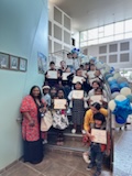 Students at Art show with certificates 