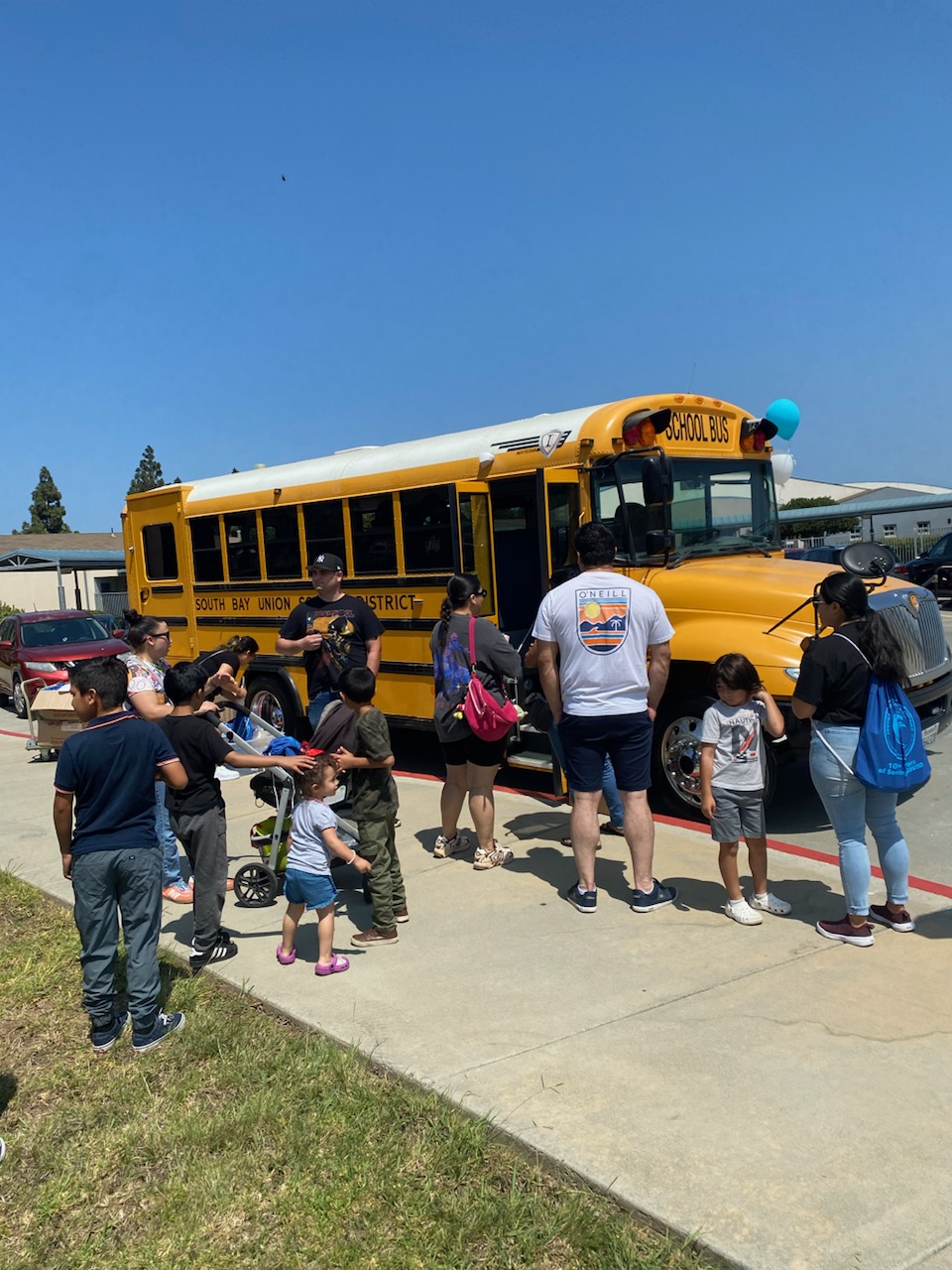 Parents and students at South Bay Kick off event with school bust