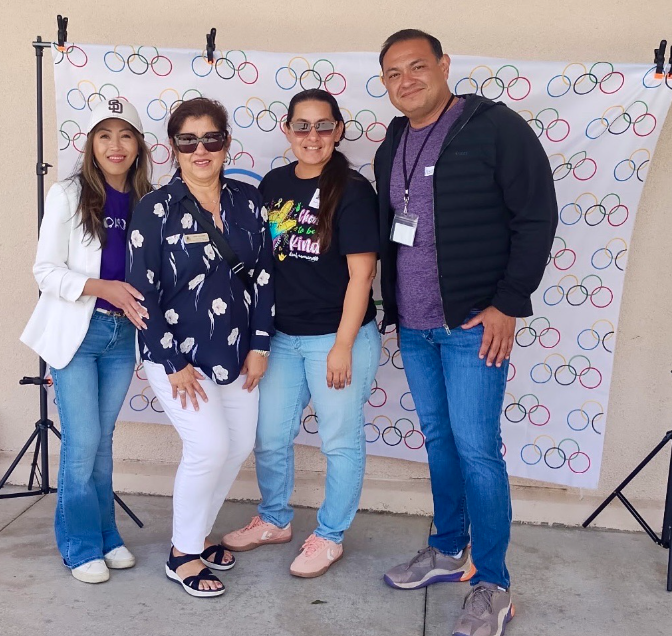 Staff members posing for a photo as volunteers at special olympics event