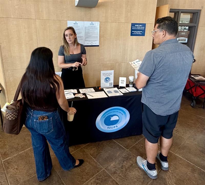 SELPA staff speaking with parents at resource fair