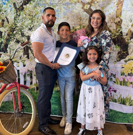 Highlighted staff with her family at Art Exhibition event