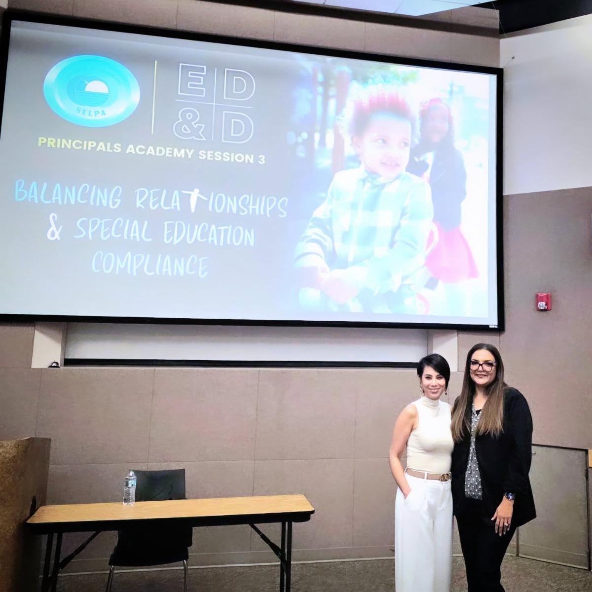 SELPA staff in front of image of students presenation 