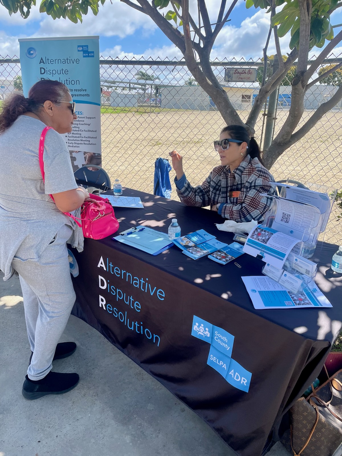staff and parent at resource table