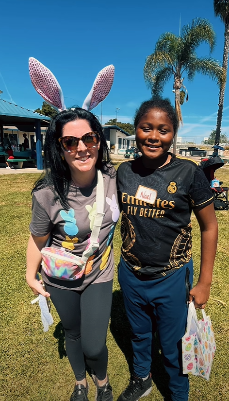 image of staff with bunny ears at beeping egg hunt event with student