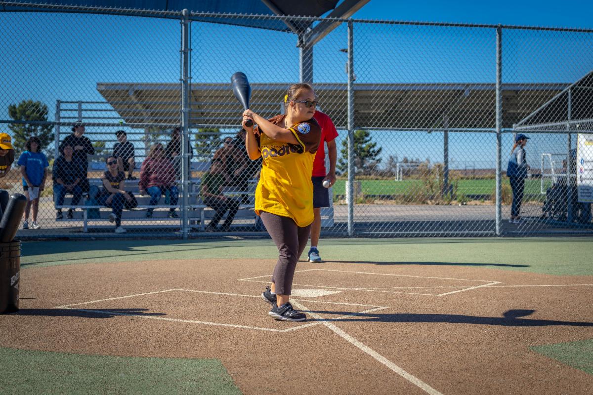player swinging a bat at miracle league opening day