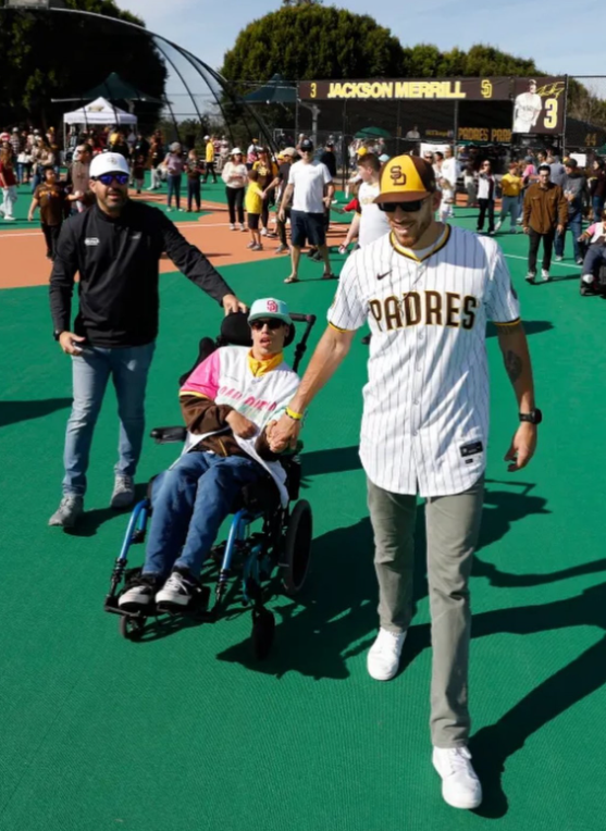 MLB player Joe Musgrove walking with Davey Vellon and his dad