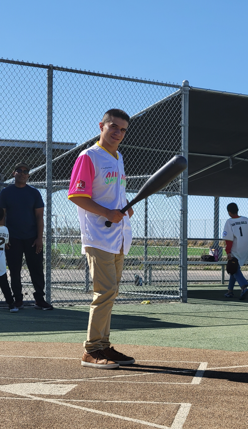 Boy holding a baseball bat at Miracle League game
