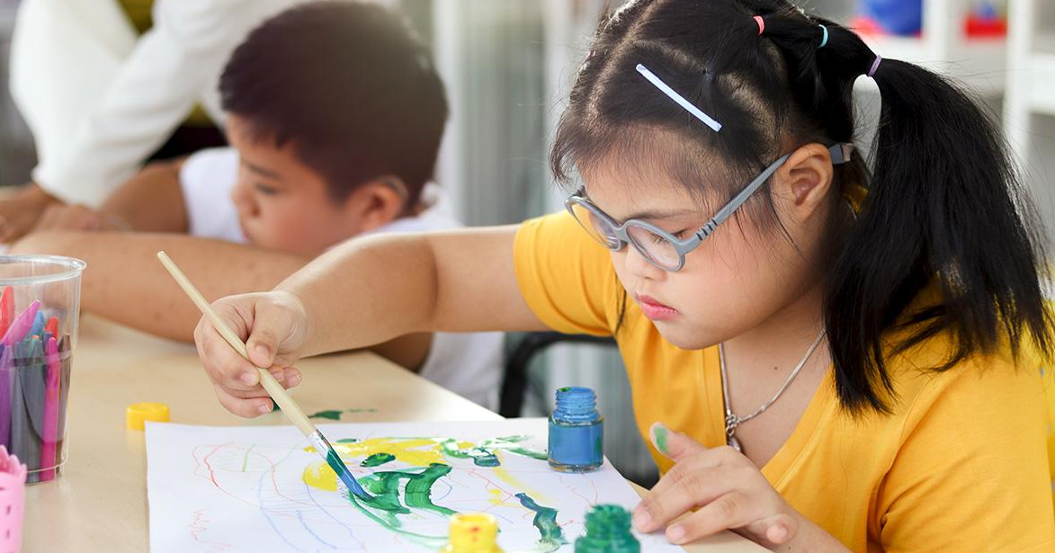 Students working on painting in a classroom setting