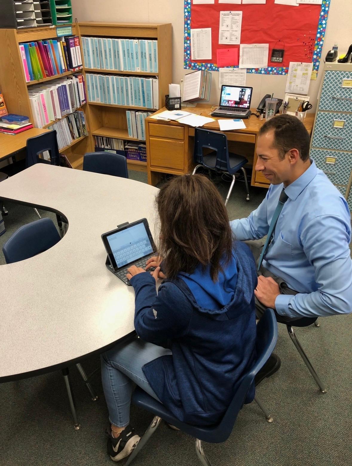 Mr. Voelker working with a student in the classroom
