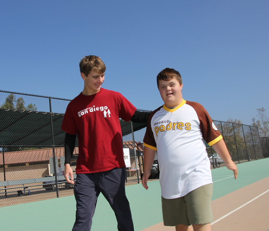 A player and buddy walking the bases together