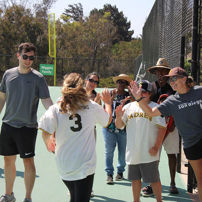 Miracle League players and buddies celebrating together on the field