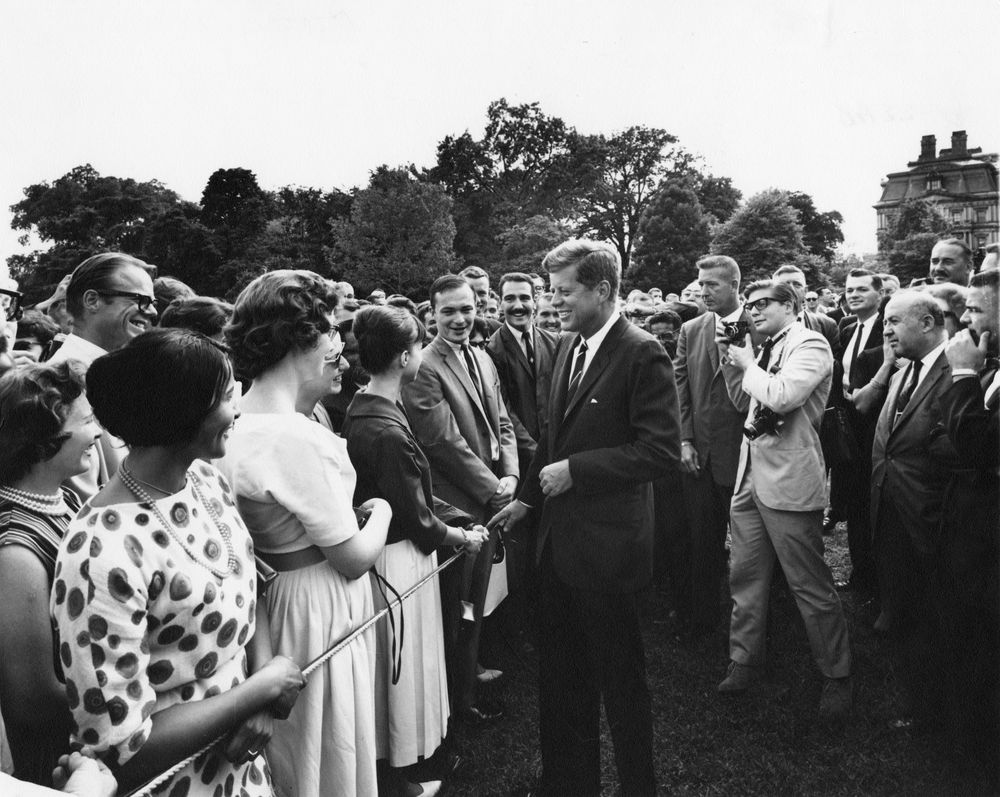 President John F. Kennedy visits with a group of Peace Corps trainees.