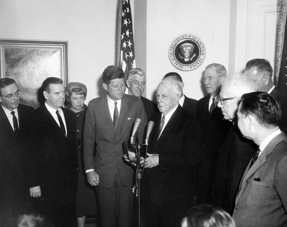 President John F. Kennedy presents a Congressional Gold Medal to poet Robert Frost in the Fish Room (Conference Room), White House, Washington, D.C.
