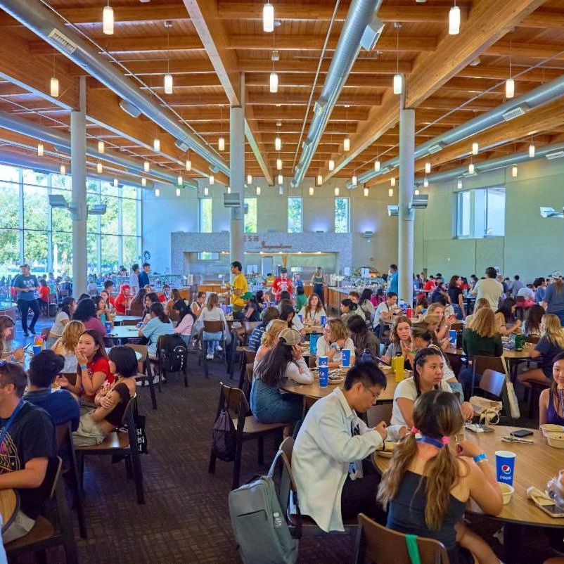 Photo of Segundo dining commons with students sitting around eating