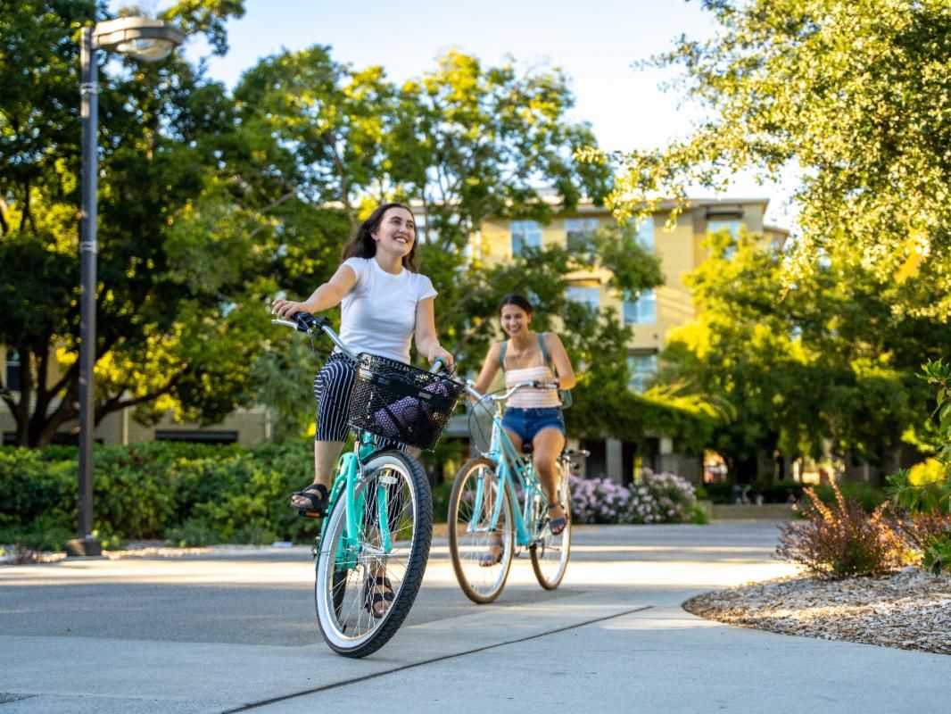 Two women riding bikes