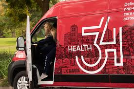 Photo of a healthcare provider entering the red Health 34 van. 