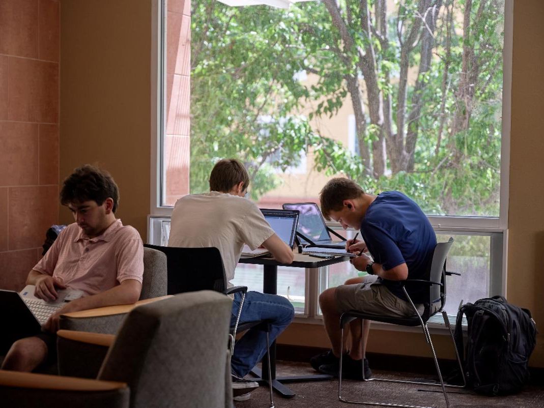 Three men studying