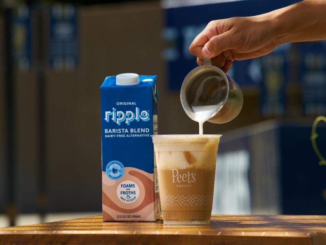 Ripple milk carton with someone pouring ripple milk into a coffee