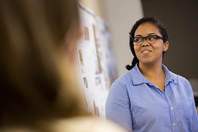 grad student looking at posters
