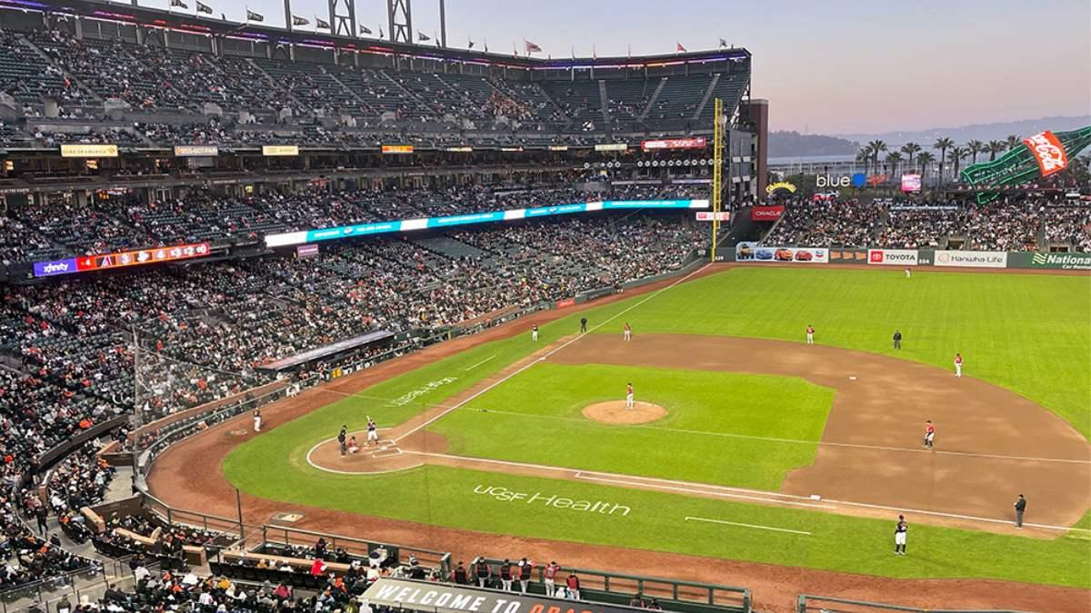 Oracle park at sunset filled with people.