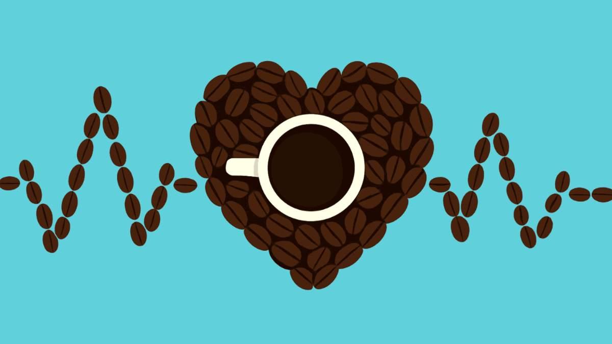 Cup of coffee surrounded by coffee beans in the shape of a heart with a heartbeat line