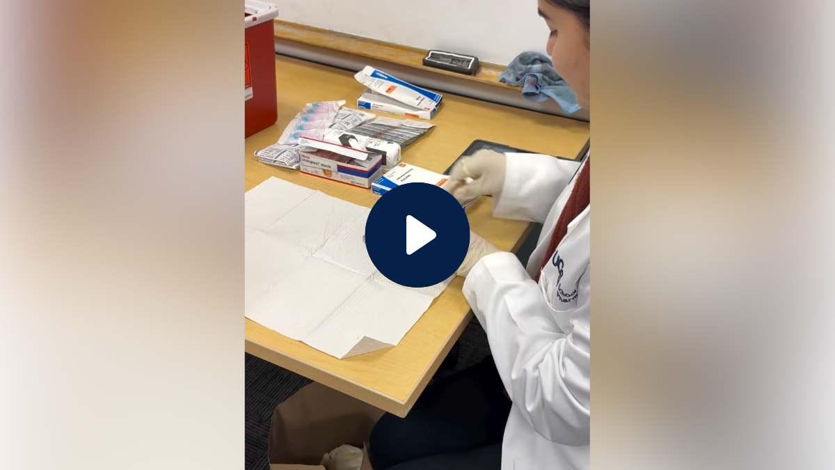 Pharmacist prepares tools for flu shot.