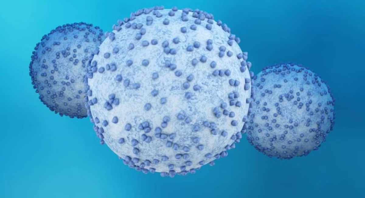 Medical illustration showing three spherical cancer cells with textured surfaces against a blue background.