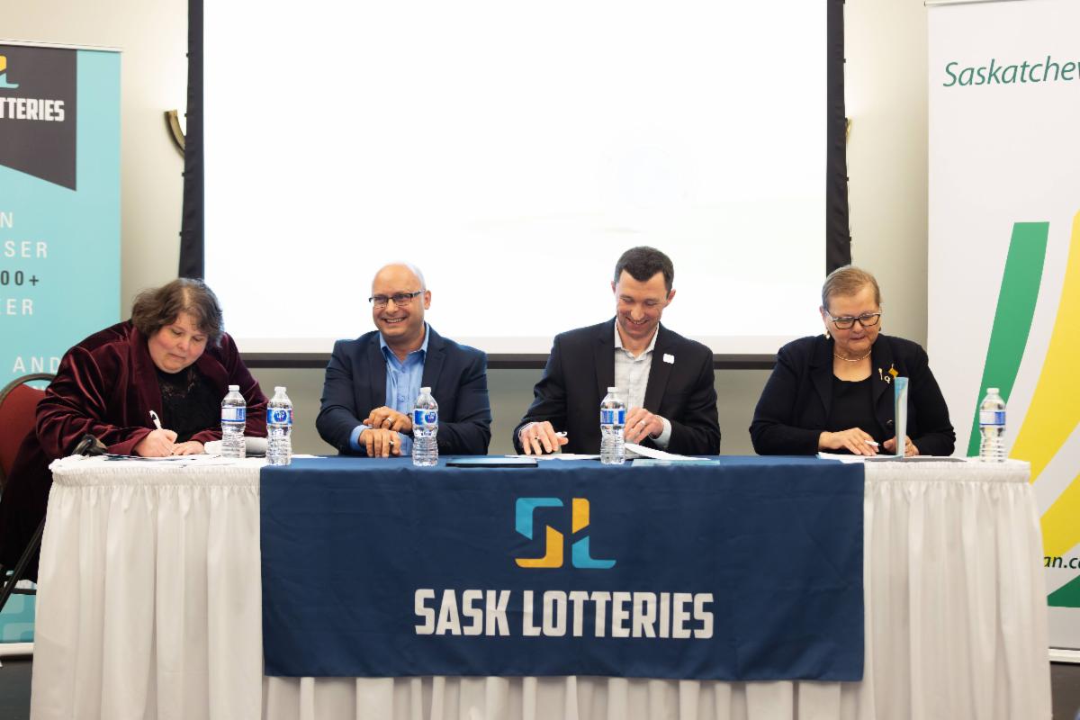 Photo of individuals signing the lottery renewal agreement